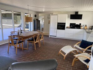 A kitchen with white cabinets, a black oven, and a black range hood.