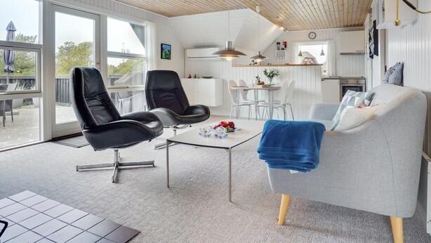 A modern living room with a large window, a dining area, and a kitchen. - "Vladan" - 1.6km from the sea by Interhome (Blåvand)