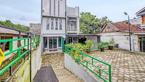 Un patio con un edificio moderno, una escalera y plantas en macetas.