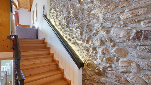 A wooden staircase with a stone wall on one side. - Holiday Home 'Pollicina' with Mountain View and Balcony (Margno)