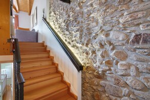 A wooden staircase with a stone wall on one side. - Holiday Home 'Pollicina' with Mountain View and Balcony (Margno)