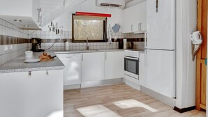 A modern kitchen with white cabinetry, a built-in oven, and a coffee machine. - "Sighrik" - 30km from the sea by Interhome (Toftlund)