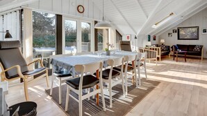 A spacious loft with a high ceiling, large windows, a dining area with a table and chairs, and a cozy seating area with a sofa and armchairs. - "Sighrik" - 30km from the sea by Interhome (Toftlund)