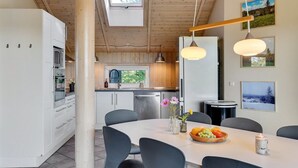 A modern kitchen with white cabinets, a large window, and a skylight. - "Merja" - 3km from the sea by Interhome (Ebeltoft)