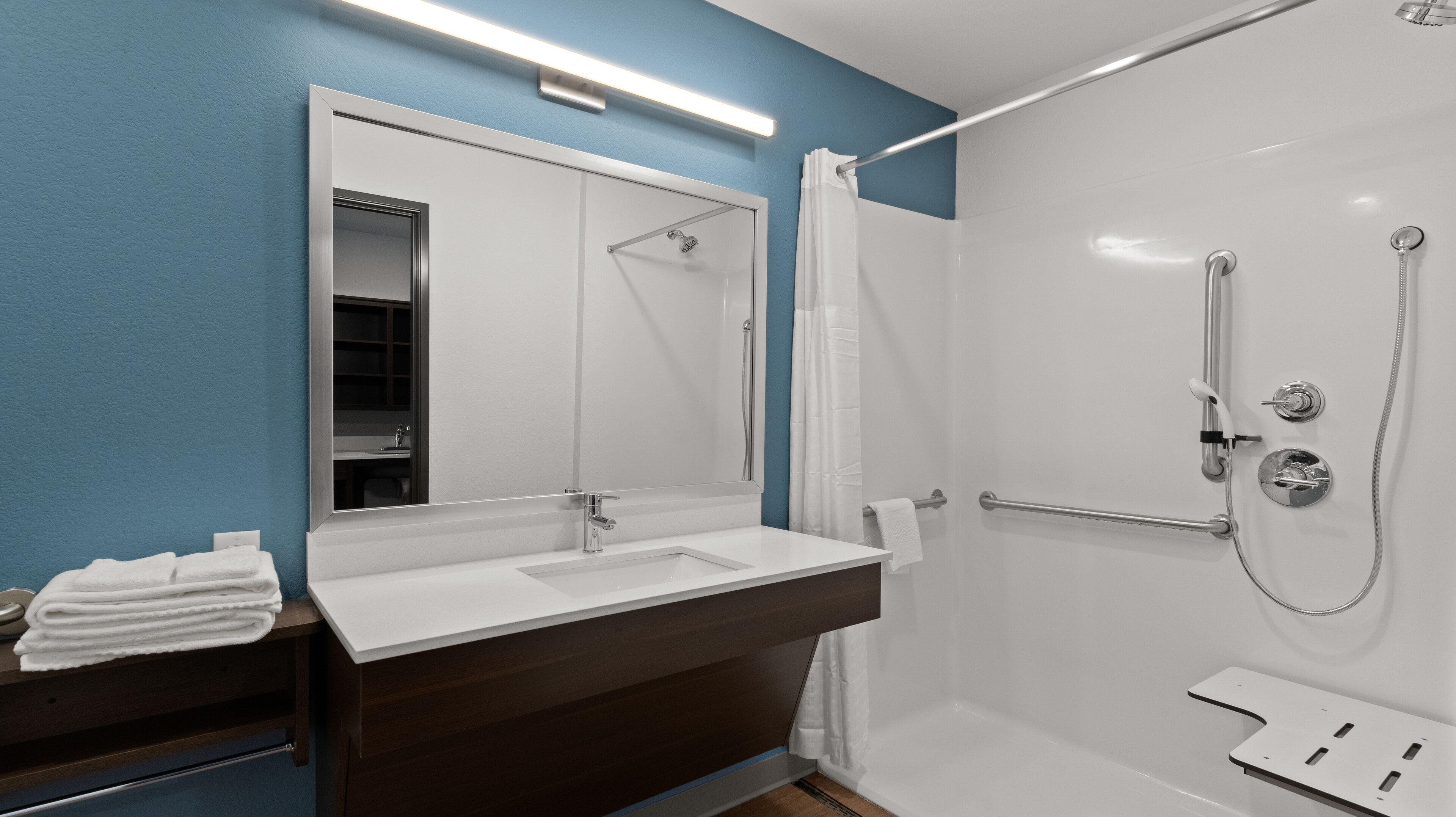 Suite, 1 Queen Bed, Accessible, Non Smoking | Bathroom | Combined shower/tub, rainfall showerhead, soap, shampoo