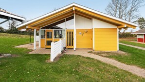 A modern house with a yellow facade, a covered porch, and a garage. - "Boris" - 500m from the sea by Interhome (Aabenraa)