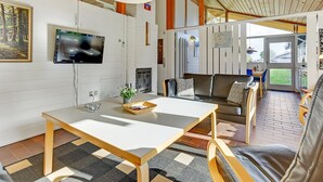 A modern living room with a white table, leather sofa, and a TV mounted on the wall. - "Boris" - 500m from the sea by Interhome (Aabenraa)