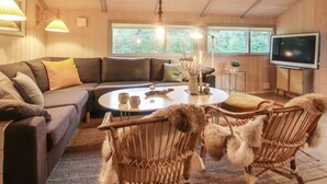 A cozy living room with a sectional sofa, a round coffee table, and a TV. - "Lovisa" - 500m from the sea by Interhome (Løkken)