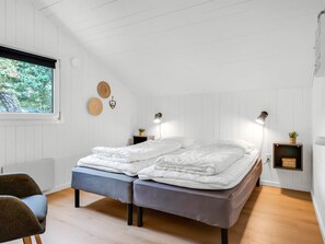 A bedroom with two beds, a window, and a view of trees. - "Jensen" - 700m to the fjord by Interhome (Oksbøl)