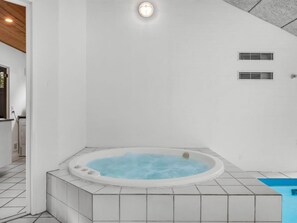 A modern bathroom with a freestanding bathtub, white tiled walls, and a visible ceiling vent. - "Jensen" - 700m to the fjord by Interhome (Oksbøl)