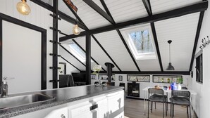 A modern kitchen with a large island, black and white cabinetry, and a skylight. - "Elisabeta" - 28km from the sea by Interhome (Toftlund)