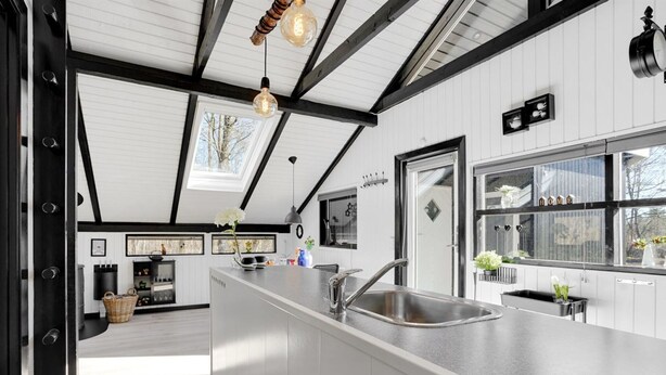 A modern kitchen with a large island, black and white cabinetry, and pendant lighting. - "Elisabeta" - 28km from the sea by Interhome (Toftlund)