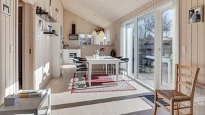 A modern kitchen with a dining area, large windows, and a view of the outdoors. - "Jil" - 750m from the sea by Interhome (Hals)