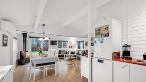 A modern kitchen with white cabinetry, a built-in stove, and a coffee maker. - "Staffan" - 200m to the fjord by Interhome (Skjern)