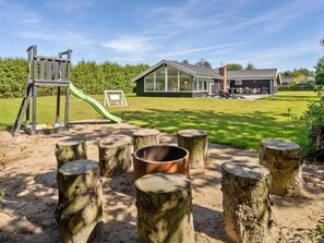 Enjoy family-friendly fun in this outdoor play area with a slide and climbing structure.