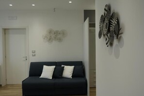 Luxury Quadruple Room, 1 Bedroom | Living area | 43-inch flat-screen TV with digital channels