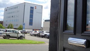 A building with a large sign reading "University of Sunderland" and a parking lot with several cars. - Perfect Location for City Centre-university (Sunderland)