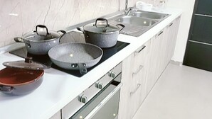 A modern kitchen with a white countertop, stainless steel appliances, and a marble backsplash. - Villa with pool (Pompei)