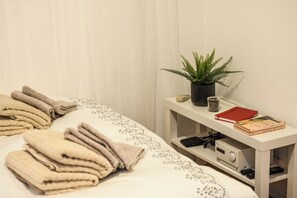 Desk, iron/ironing board, bed sheets