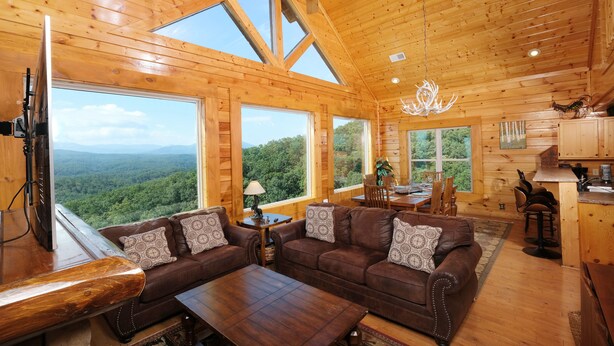 A spacious cabin with wooden walls and large windows offering a view of the forest. - Starry Starry Night: Count Stars, Not Worries (Sevierville)
