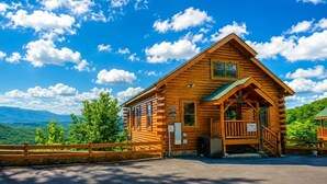 A wooden cabin with a porch, a sign indicating it is a lodge, and a view of the mountains. - Starry Starry Night: Count Stars, Not Worries (Sevierville)