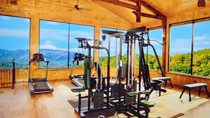 A gym with exercise equipment and large windows offering mountain views. - Starry Starry Night: Count Stars, Not Worries (Sevierville)
