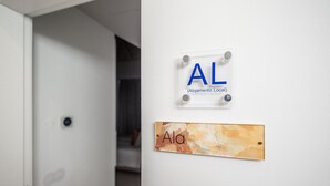 A wall with two signs: one labeled 'AL' and another with 'Ala'. - Suits Boutique Ala - Studio mezanino by HD (Faro)