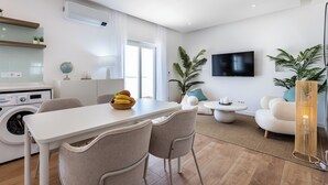 A modern apartment with a dining area, kitchen, and living space. - City Centre Ocean View Apartment (Lagos)