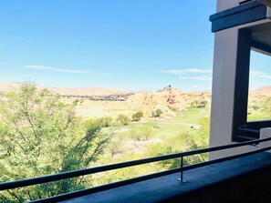A view from a balcony overlooking a golf course with a clear sky. - Fairway Vista Retreat by Mesquite Vacation Rentals with Golf Course View at Wolf Creek with $510 in free daily activities (Mesquite)