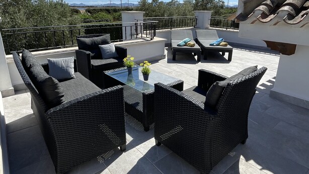 A rooftop patio with wicker furniture, a glass table, and a view of the landscape. - 2 Bedroom Villa With Heated Pool (Torre-Pacheco)