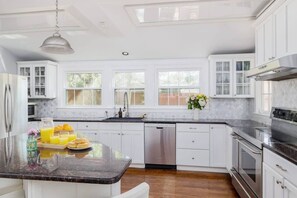 Enjoy cooking in this well-equipped kitchen with a large island, sink, and ample counter space.