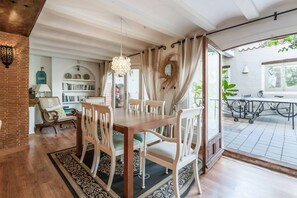 Enjoy meals in this dining area with a wooden table and comfortable seating for all.