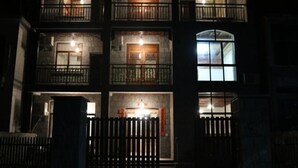 A multi-story building with balconies and windows, featuring a gated entrance. - Ziyan Shanju Inn (Deqing)