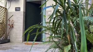 A building entrance with a closed door, an air conditioning unit, and a sign that reads "EUROPEAN PARTMENT". - [European Apartment] Town Center + Self Check-in (Catania)