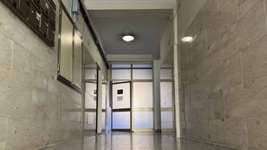 A corridor with a polished floor, tiled walls, and a door at the end leading to a room with a window. - [European Apartment] Town Center + Self Check-in (Catania)