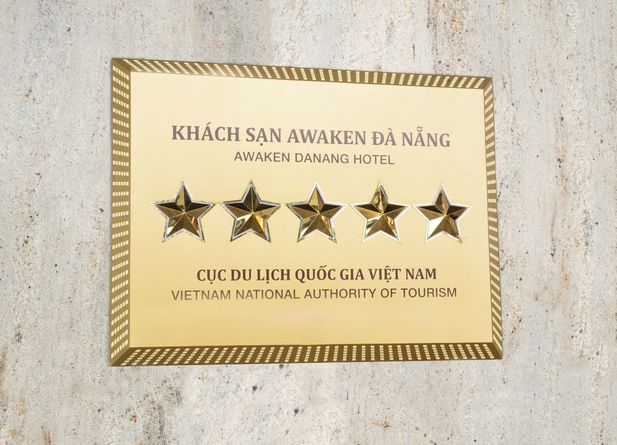 A plaque with text and five stars, indicating a rating or recognition.
