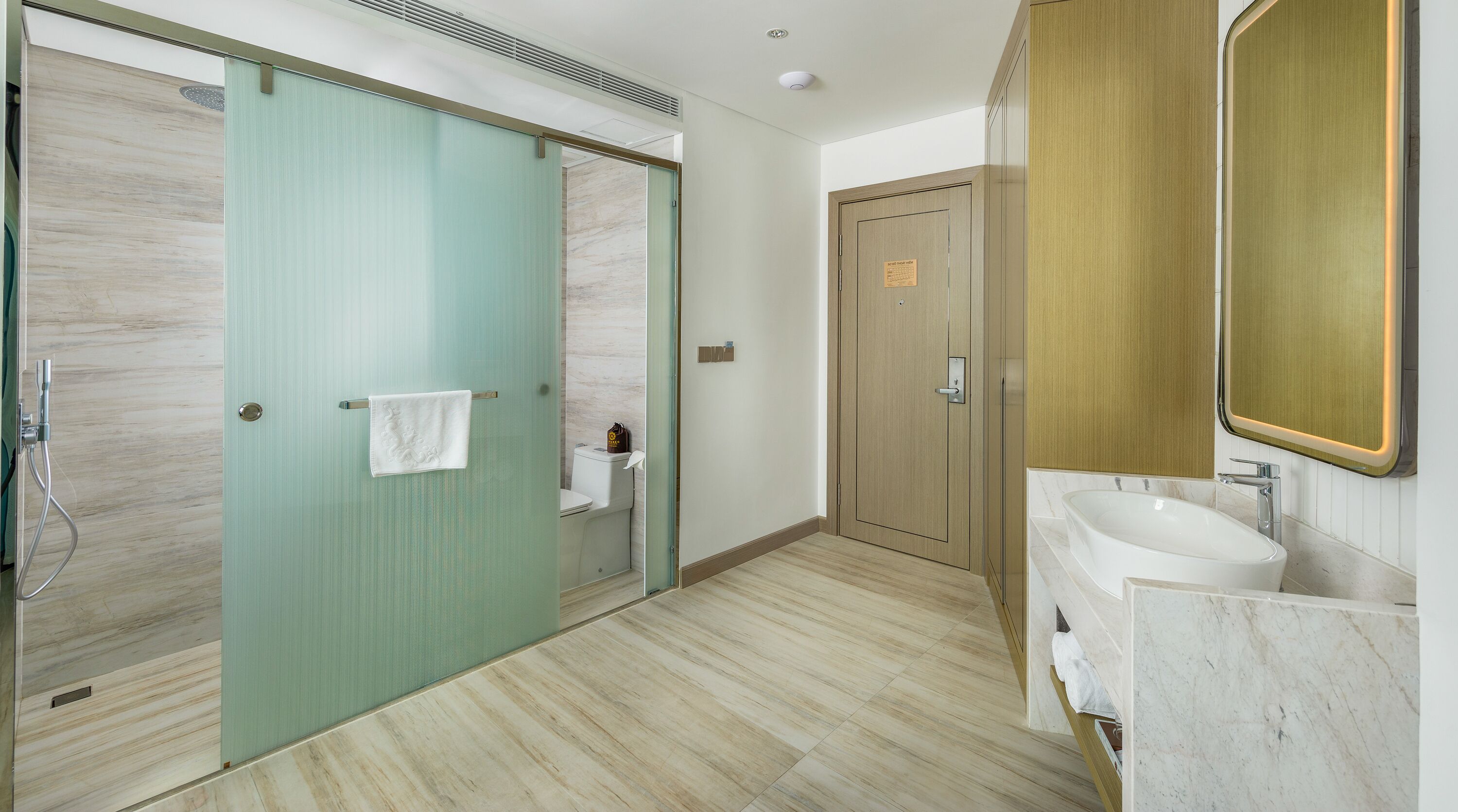 A bathroom with a shower, toilet, and sink.