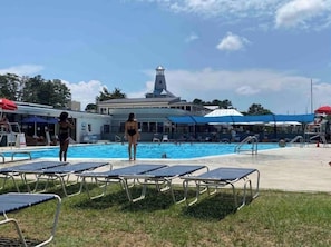 Relax by the pool surrounded by lush greenery and enjoy the tower's scenic views.