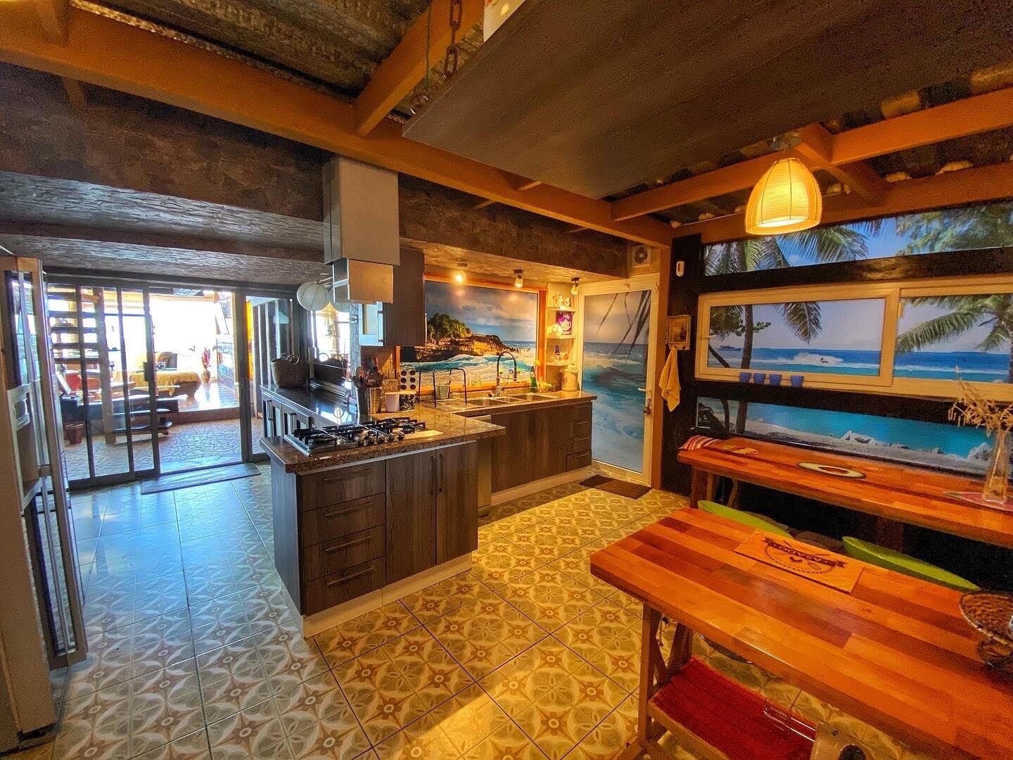 A kitchen with a gas stove, wooden cabinets, and a patterned tile floor.