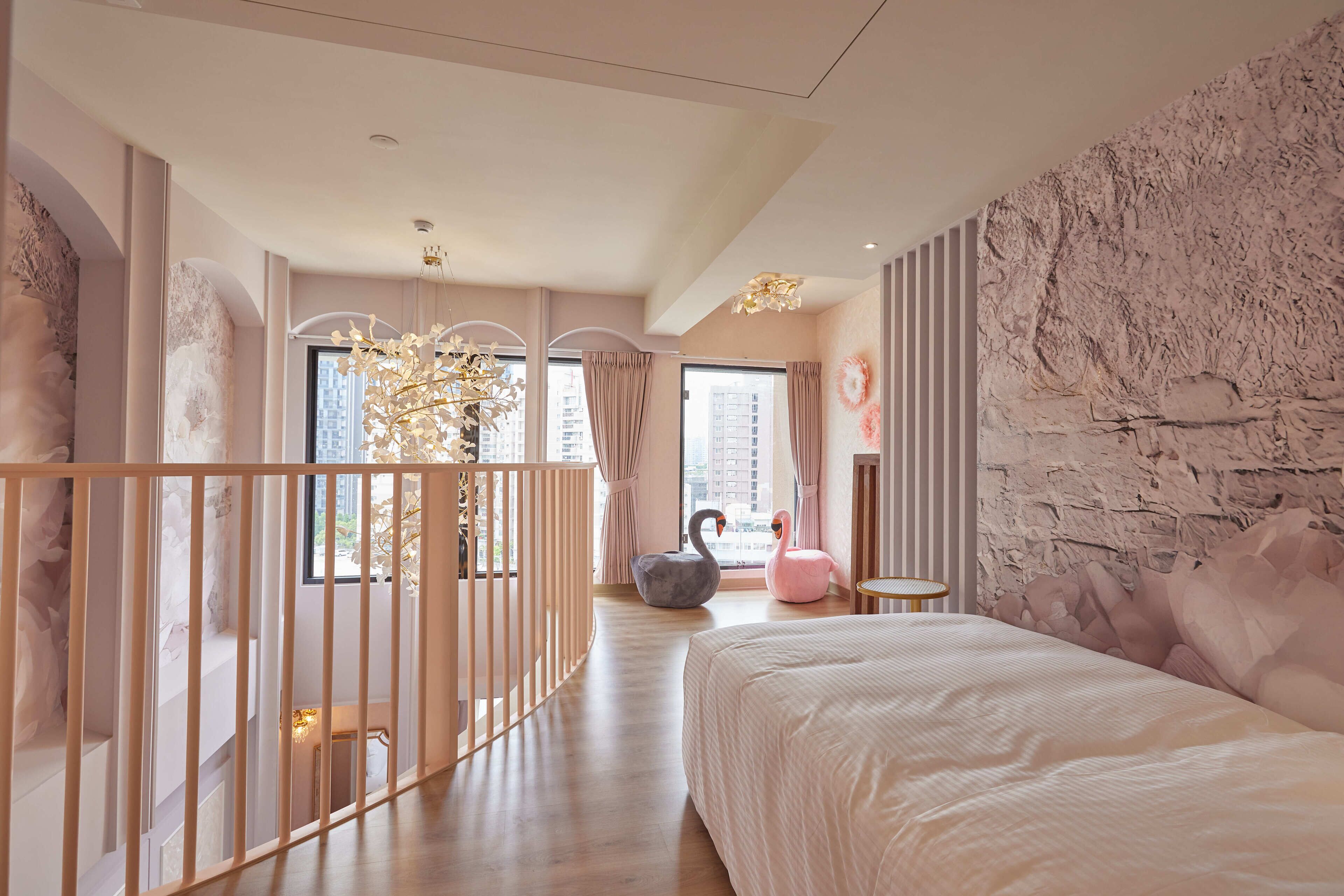 A modern bedroom with a large bed, a view of the city, and a unique wall texture.