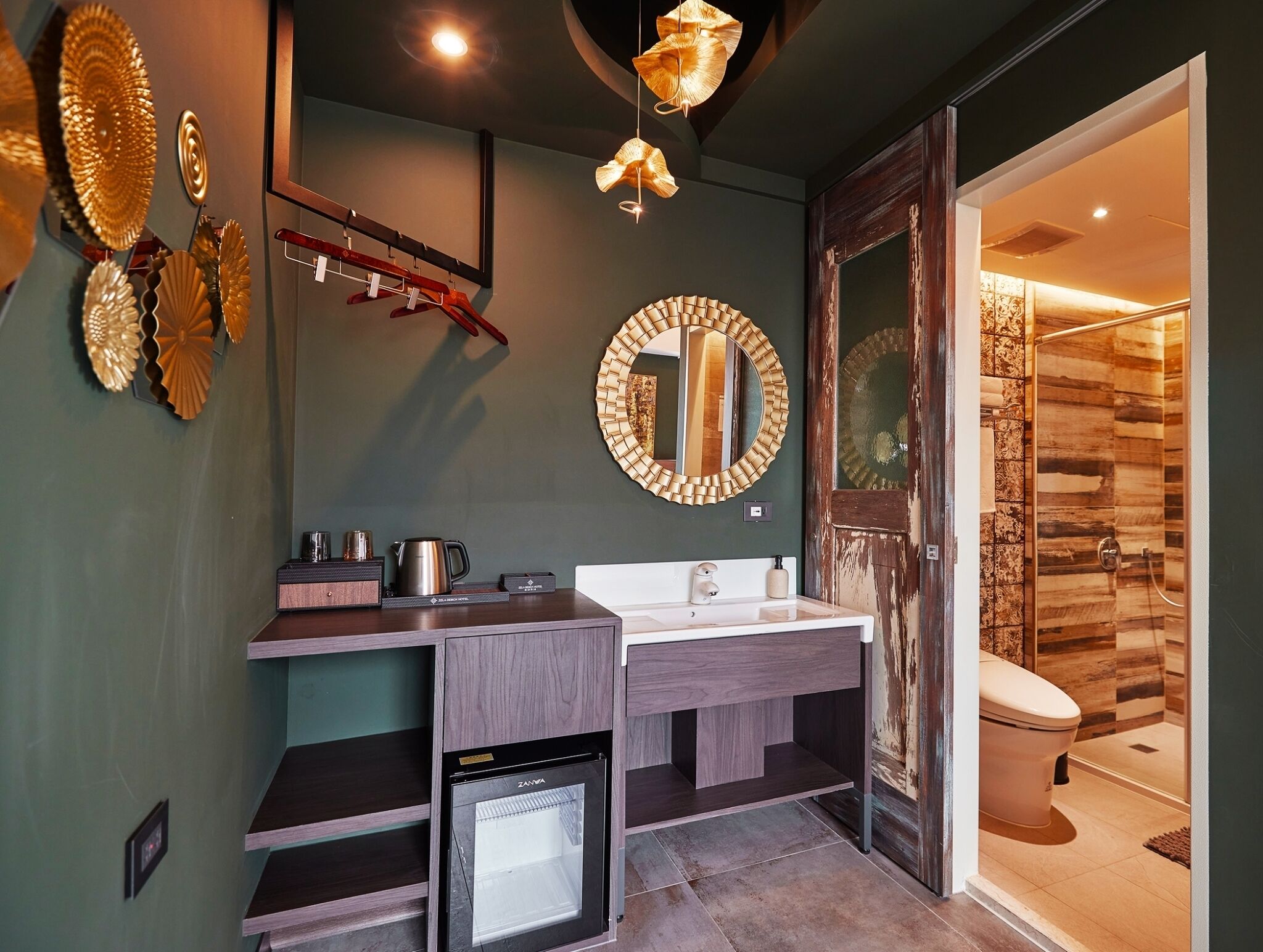 A modern bathroom with a built-in dishwasher, a large mirror, and a shower with wooden paneling.