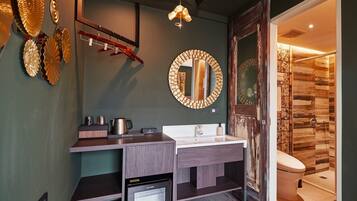 A modern bathroom with a built-in dishwasher, a large mirror, and a shower with wooden paneling.