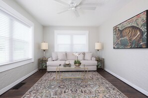 Relax in this inviting living space with a comfortable sofa, two nightstands, and a stylish rug.