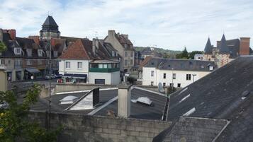 Een stad met traditionele architectuur, waaronder een kerk met een torenspits en een gebouw met een groene gevel.
