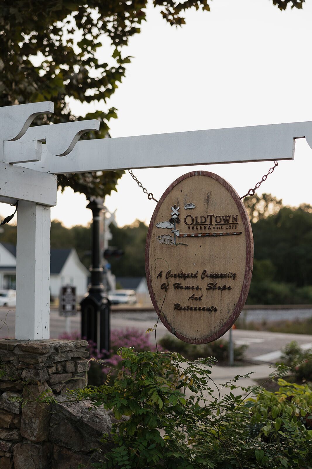 A wooden sign with the text "OldTown" and "A quaint community of homes, shops, and restaurants."