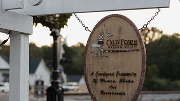 A wooden sign with the text "OldTown" and "A quaint community of homes, shops, and restaurants."