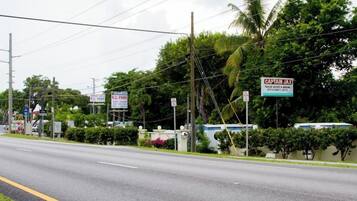 Overlooking a scenic roadside, this tropical setting offers a glimpse into a serene coastal landscape.