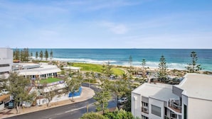 A coastal view with a road, buildings, and a beach. - Apartment M503 - panoramic ocean views for miles! (Scarborough)