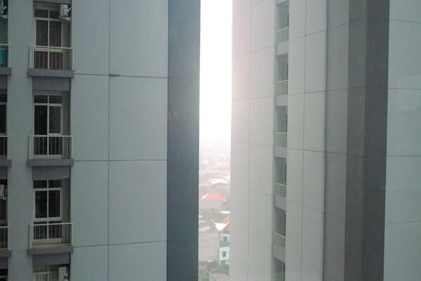 A high-rise building with a modern architectural design, featuring large windows and a clean, minimalist facade.
