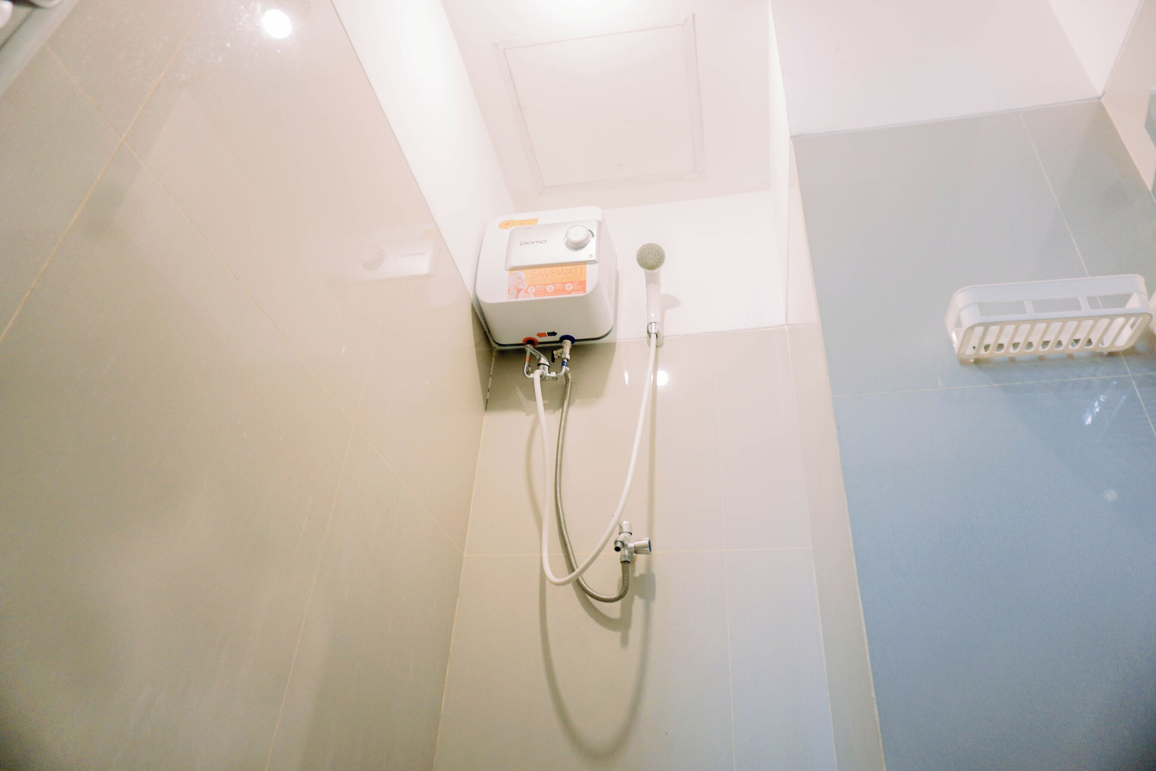 A shower with a handheld showerhead and a handheld massager.